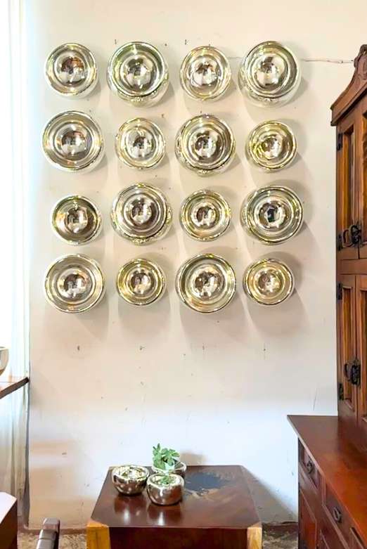 Wall of mercury blown glass bowls hung as decor